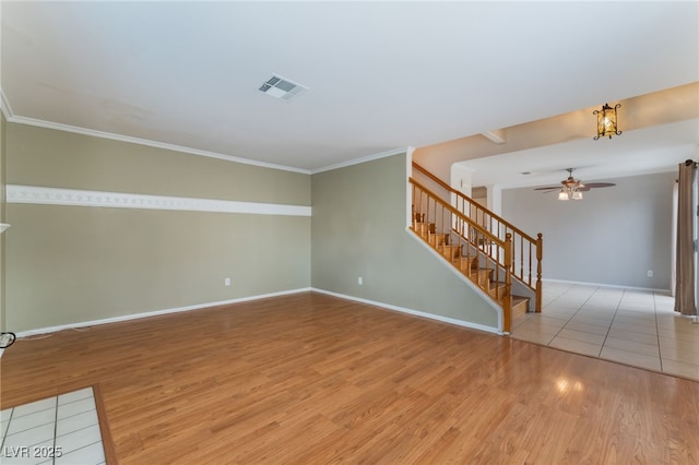 unfurnished room featuring crown molding, light hardwood / wood-style floors, and ceiling fan