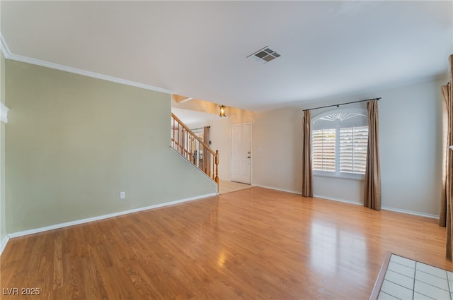 interior space with crown molding and light hardwood / wood-style flooring