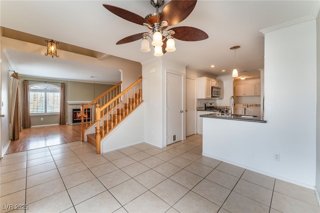 kitchen with crown molding, light tile patterned floors, white cabinets, and independent washer and dryer