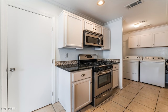 kitchen featuring white cabinetry, independent washer and dryer, appliances with stainless steel finishes, and crown molding