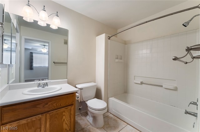 full bathroom with tile patterned flooring, vanity, tiled shower / bath combo, ceiling fan, and toilet