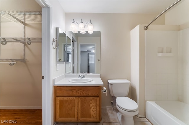 full bathroom with shower / tub combination, vanity, tile patterned floors, and toilet