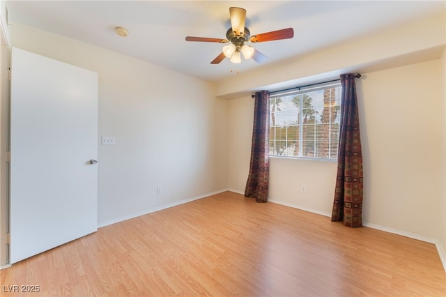 empty room with light hardwood / wood-style flooring and ceiling fan