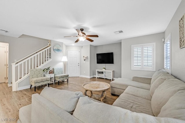 living room with ceiling fan and light hardwood / wood-style floors