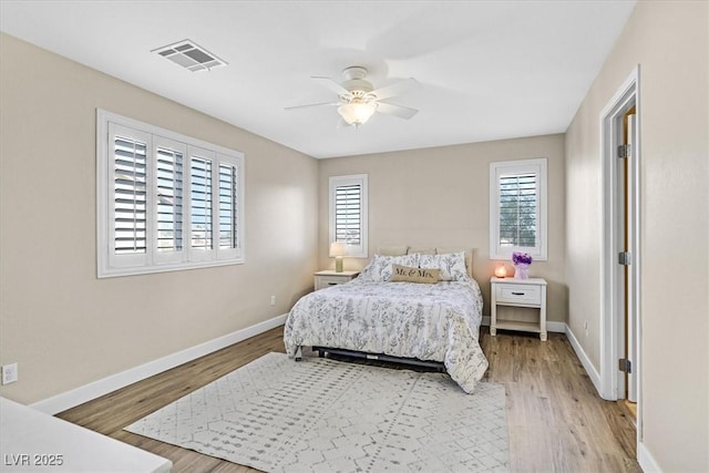 bedroom with light hardwood / wood-style floors and ceiling fan