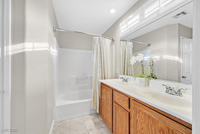 bathroom featuring vanity and shower / bath combo