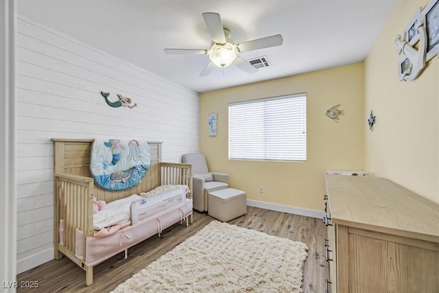 living area featuring ceiling fan and wood-type flooring