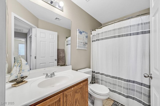 bathroom featuring vanity, tile patterned floors, and toilet