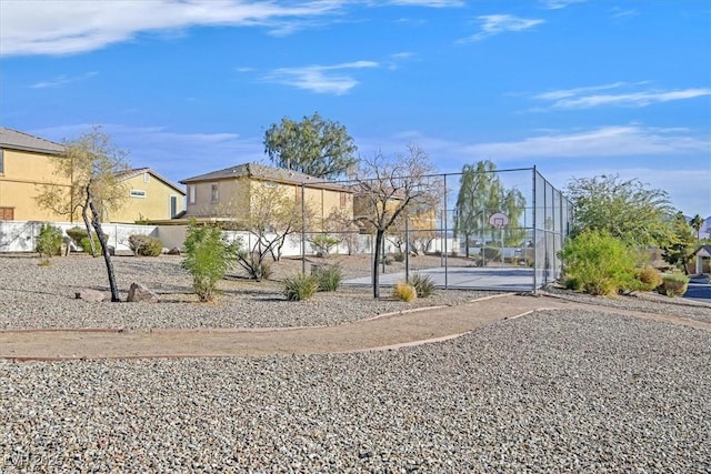 view of yard with basketball hoop