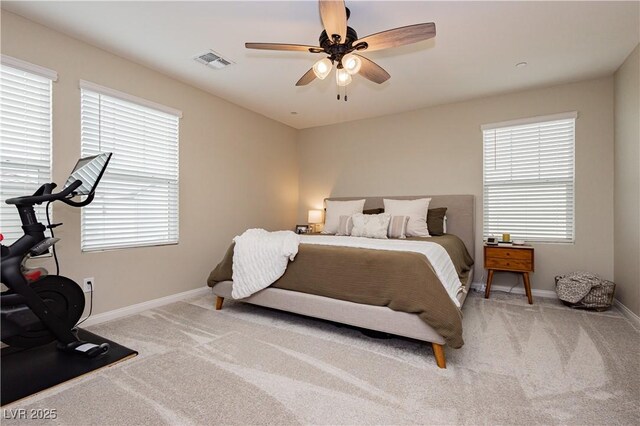 carpeted bedroom with baseboards, visible vents, and a ceiling fan