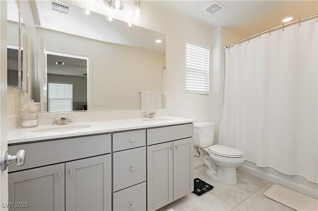 full bathroom featuring shower / bathtub combination with curtain, vanity, toilet, and plenty of natural light