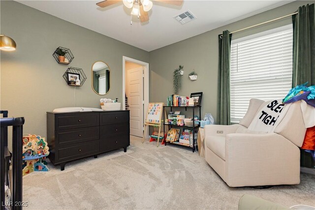 bedroom with ceiling fan and light carpet