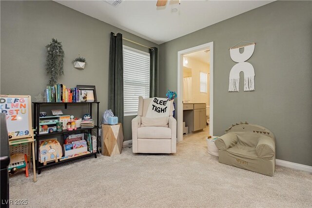 living area with carpet flooring, a ceiling fan, and baseboards