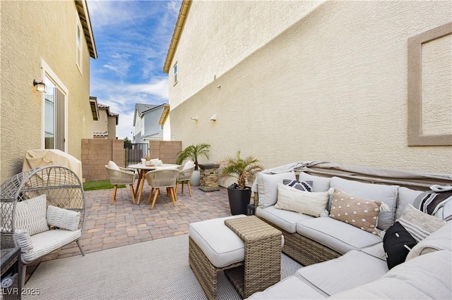 view of patio featuring outdoor dining area, outdoor lounge area, and fence