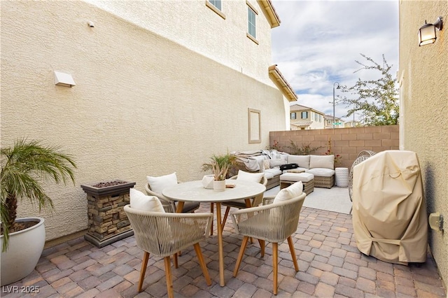 view of patio / terrace with outdoor dining space, fence, an outdoor living space, and area for grilling