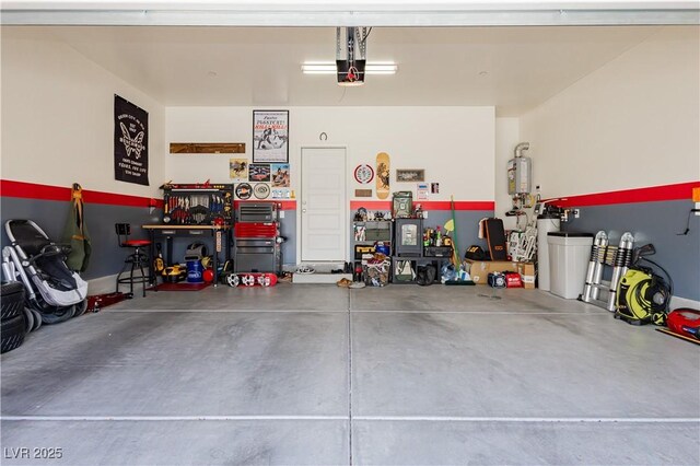 garage featuring water heater and a workshop area