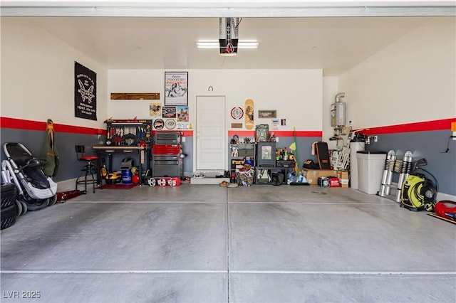 garage with water heater and a workshop area