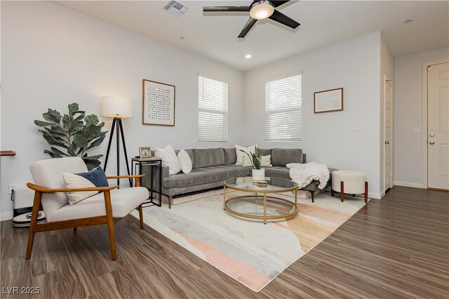 living room with ceiling fan and dark hardwood / wood-style floors