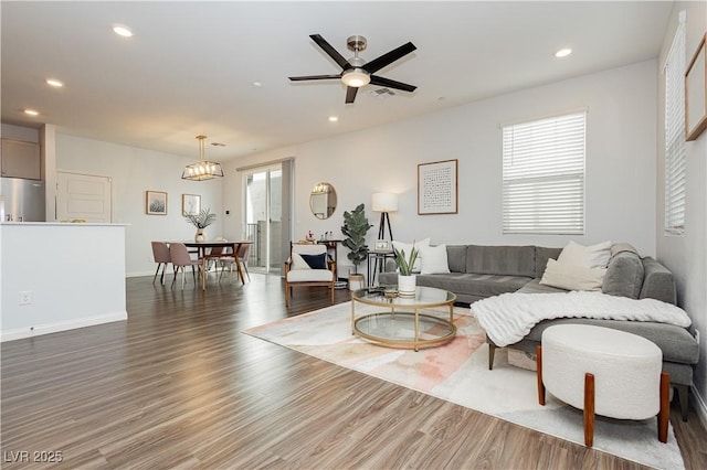 living room featuring dark hardwood / wood-style floors and ceiling fan