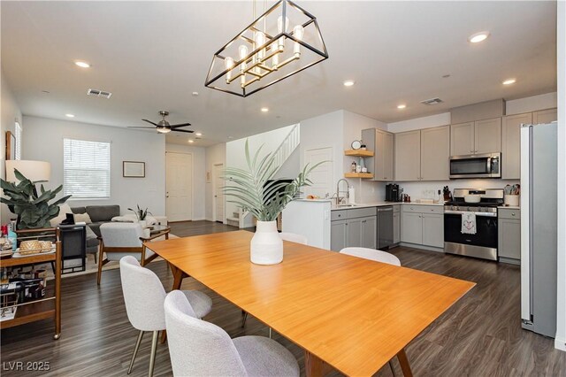 dining area with dark wood-style floors, recessed lighting, visible vents, and a ceiling fan