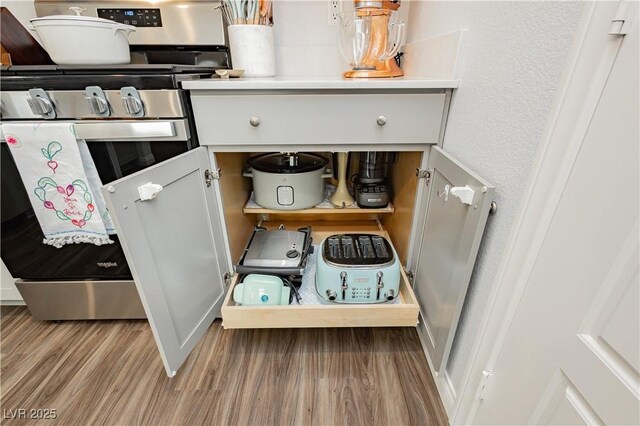 interior space with wood finished floors and gas range