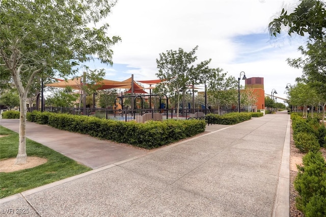 view of property's community featuring fence and playground community