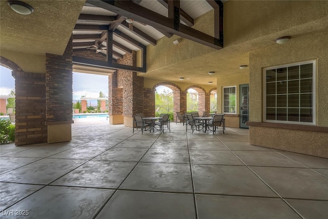 view of patio with outdoor dining area and an outdoor pool