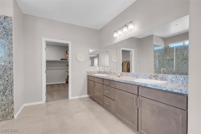 bathroom featuring a shower with door and vanity