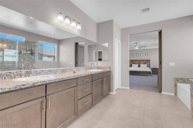 bathroom featuring tile patterned flooring, vanity, a bathing tub, and ceiling fan