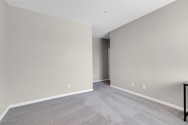 spare room with light colored carpet