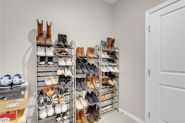 walk in closet with light tile patterned floors