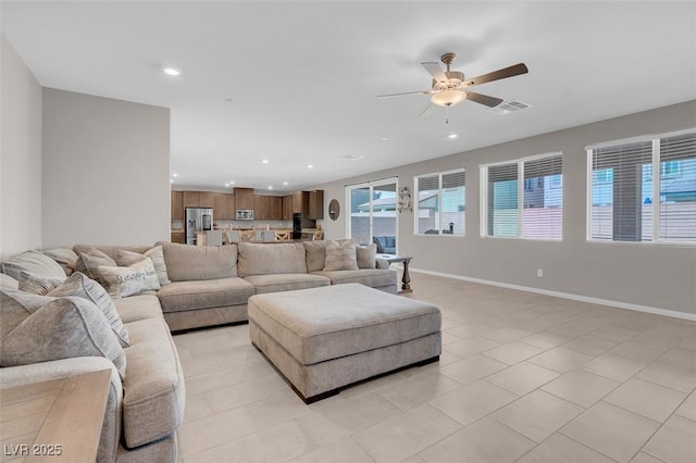 tiled living room with ceiling fan