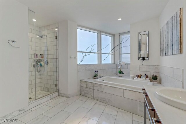 bathroom featuring independent shower and bath and vanity