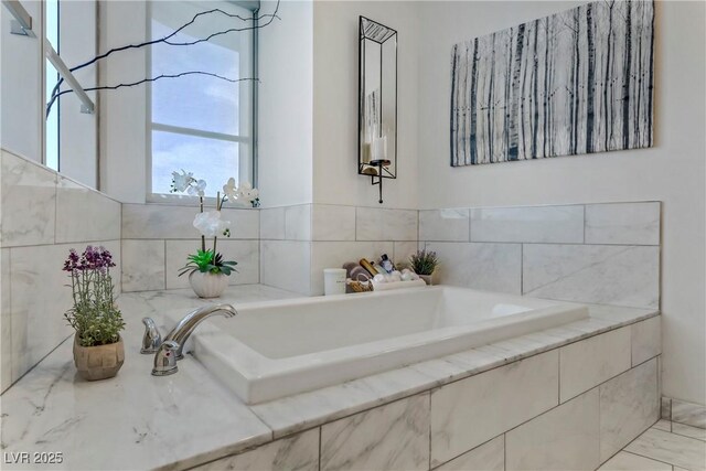 bathroom featuring tiled tub