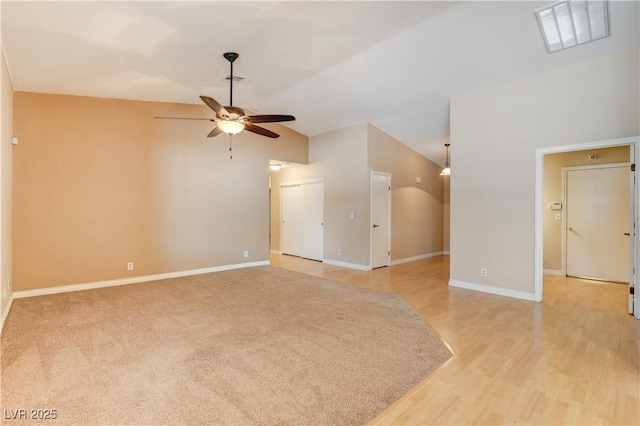 unfurnished living room with ceiling fan, light hardwood / wood-style floors, and vaulted ceiling