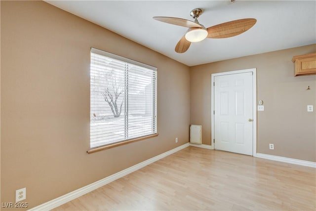 spare room with ceiling fan and light wood-type flooring