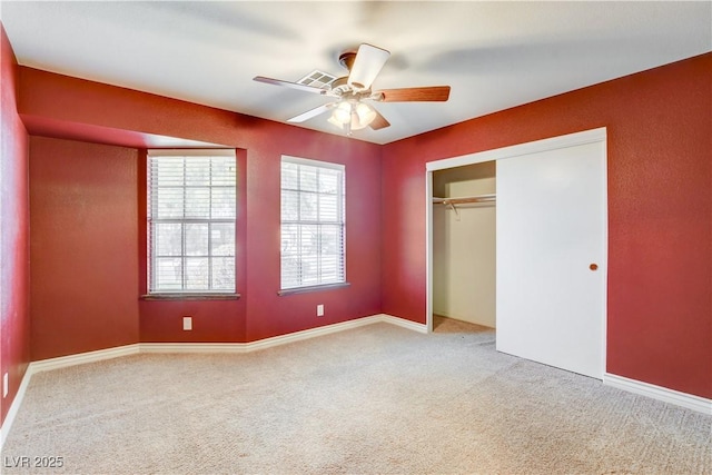 unfurnished bedroom with carpet, ceiling fan, and a closet