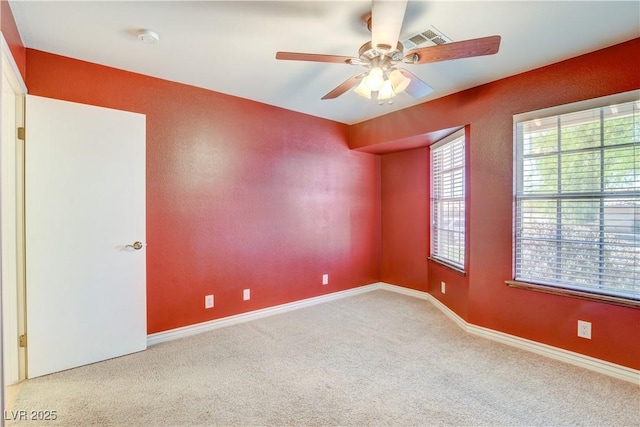 empty room with ceiling fan and carpet flooring