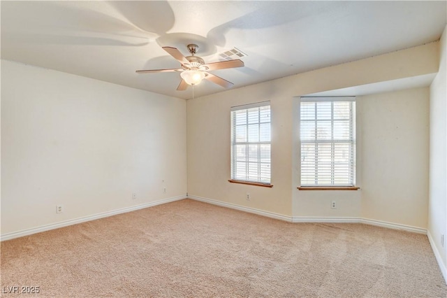 carpeted spare room featuring ceiling fan