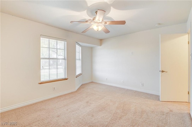 carpeted spare room featuring ceiling fan