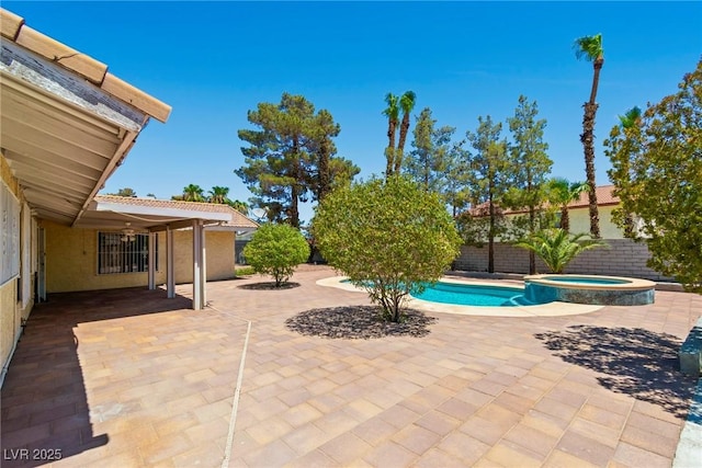 view of swimming pool featuring an in ground hot tub and a patio