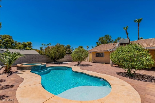 view of swimming pool featuring a patio and an in ground hot tub