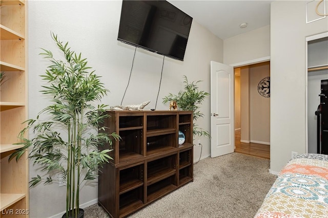 carpeted bedroom featuring baseboards