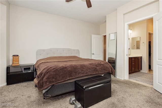 bedroom with light carpet, ceiling fan, baseboards, and ensuite bathroom