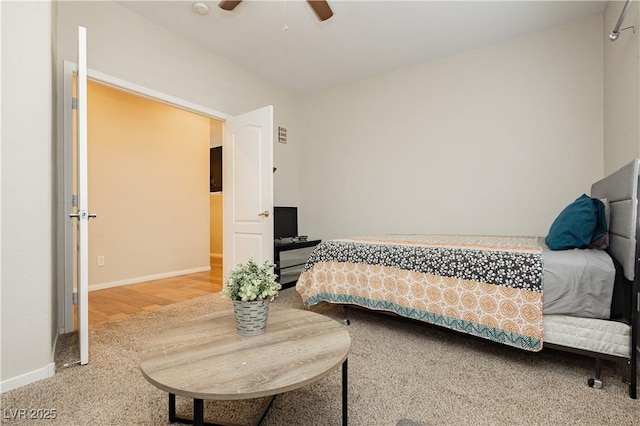 bedroom with ceiling fan, baseboards, and wood finished floors