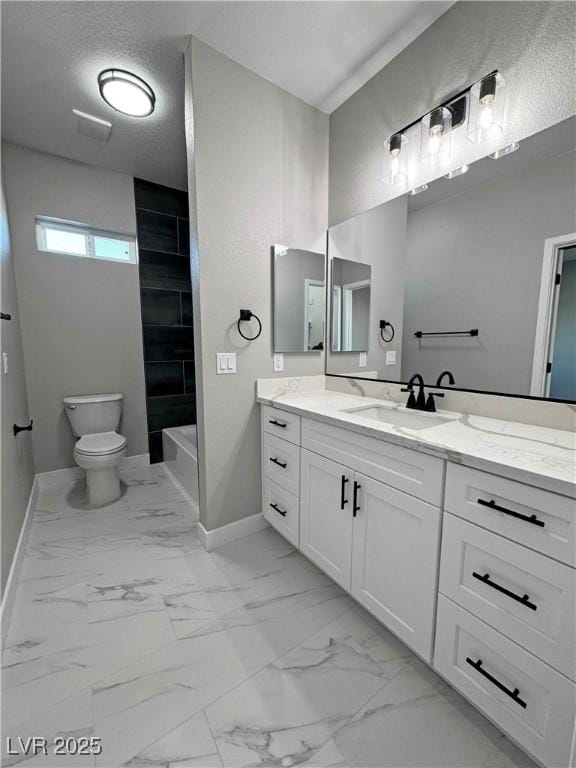 bathroom with baseboards, toilet, marble finish floor, a textured ceiling, and vanity