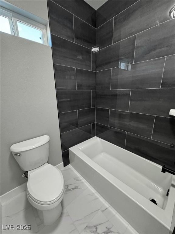 bathroom with toilet, marble finish floor, and shower / washtub combination