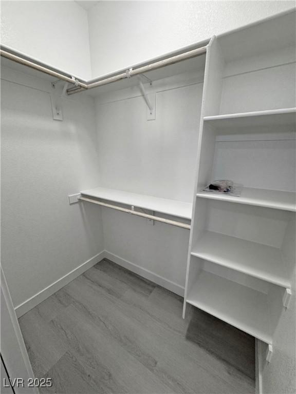 spacious closet with wood finished floors