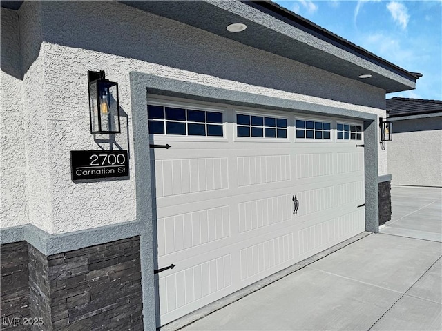 garage with concrete driveway