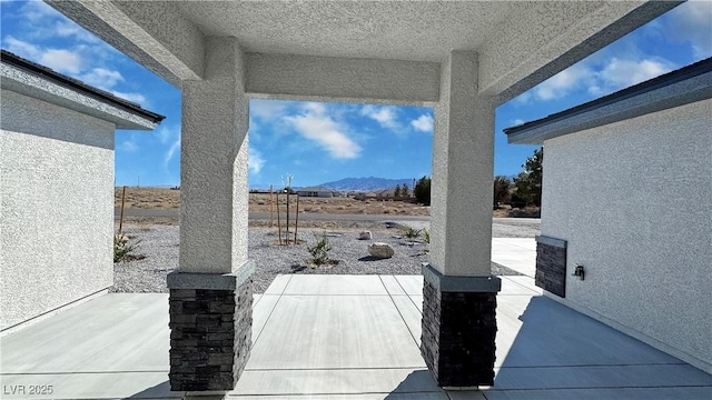 view of patio / terrace featuring a mountain view